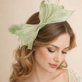 Bow Shaped Fascinator with Sinamay Curls & Feathers in Pastel Green - svnx