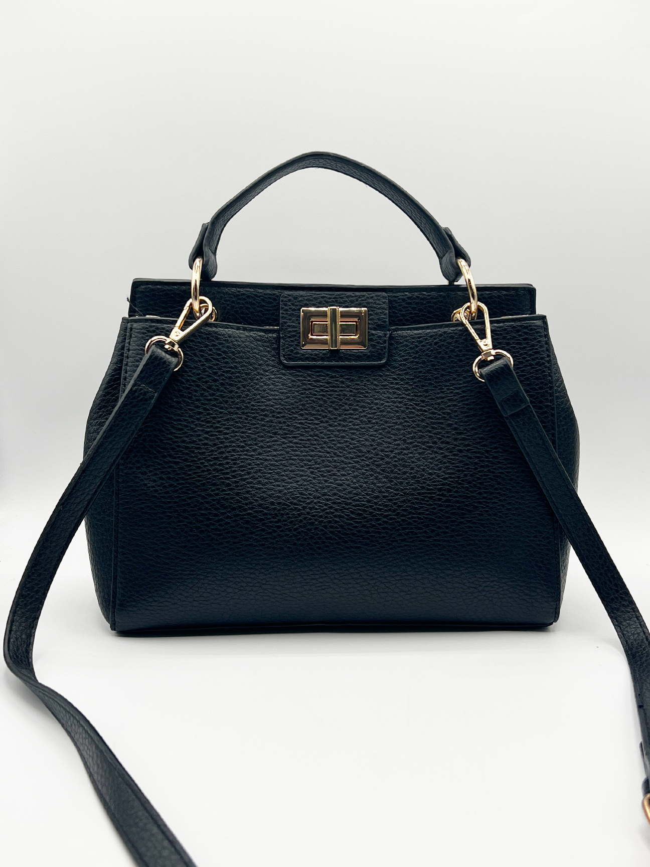 Black faux leather handbag with gold trim - svnx