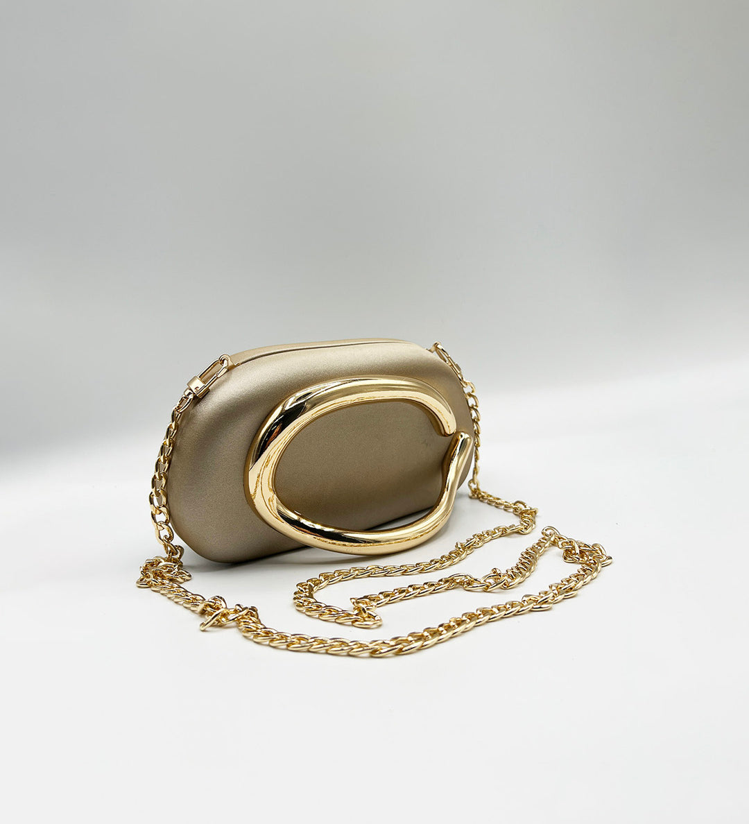 Oval Satin Hard Case Clutch Bag In Muted Gold - svnx