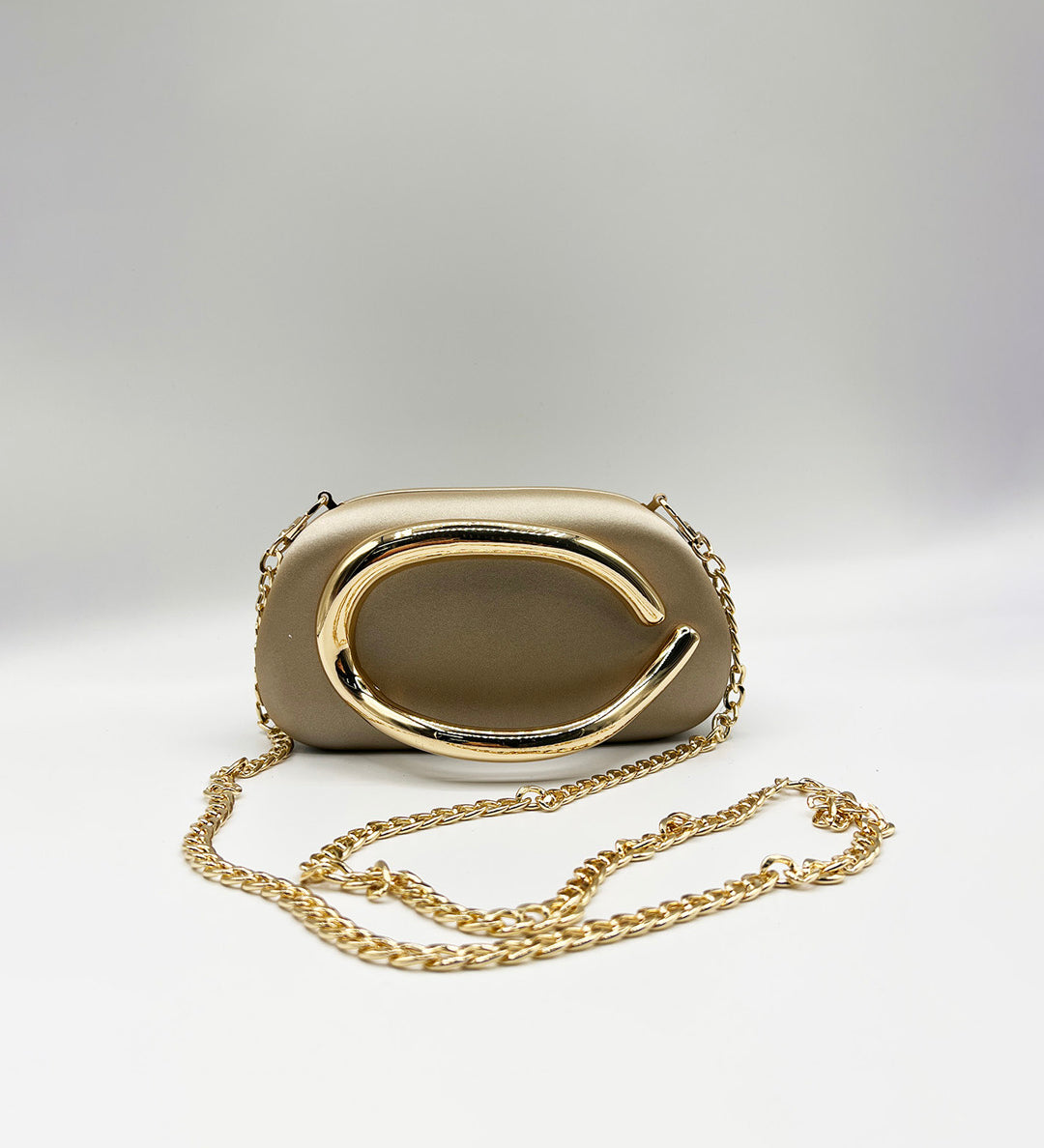 Oval Satin Hard Case Clutch Bag In Muted Gold - svnx