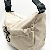 SVNX Nylon sling bag bag with drawstring front pocket in unbleached cotton